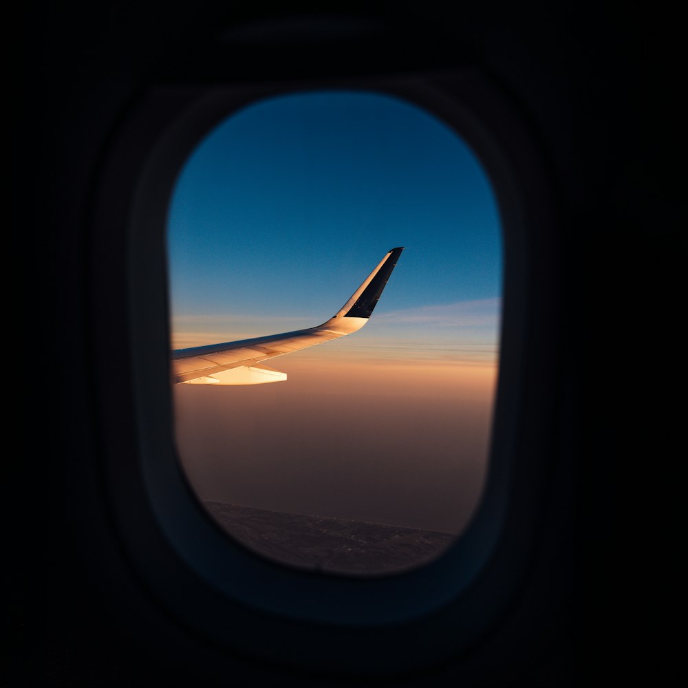 a view of the wing of an airplane through a window