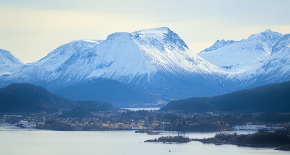 a view of a mountain range with a lake in the foreground