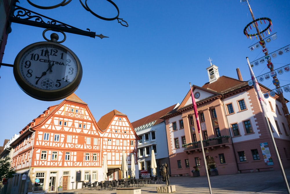 a clock hanging from the side of a building