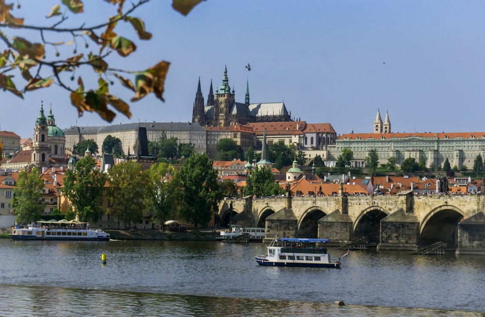 a river with a boat on it and a city in the background