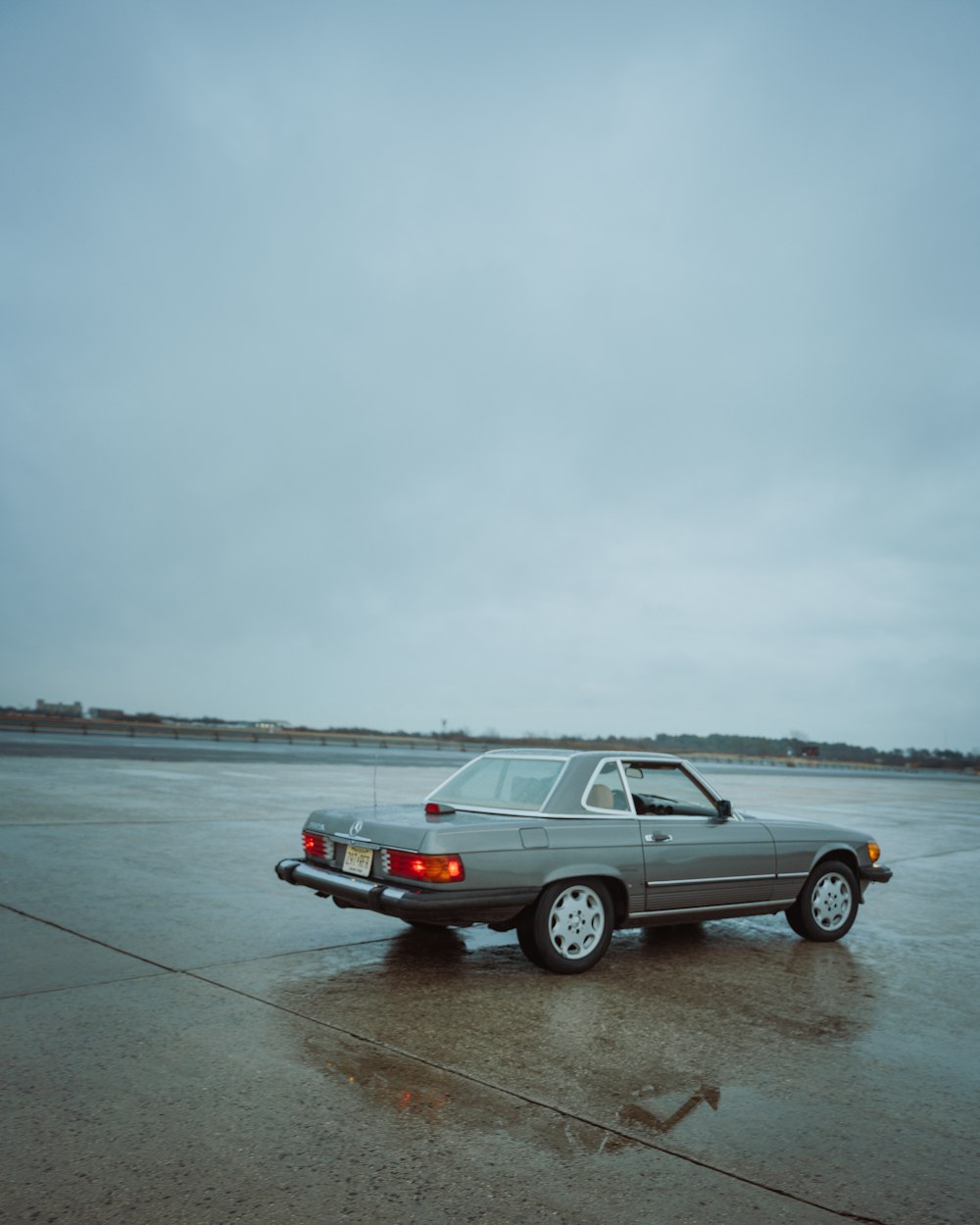 a car parked on a wet parking lot