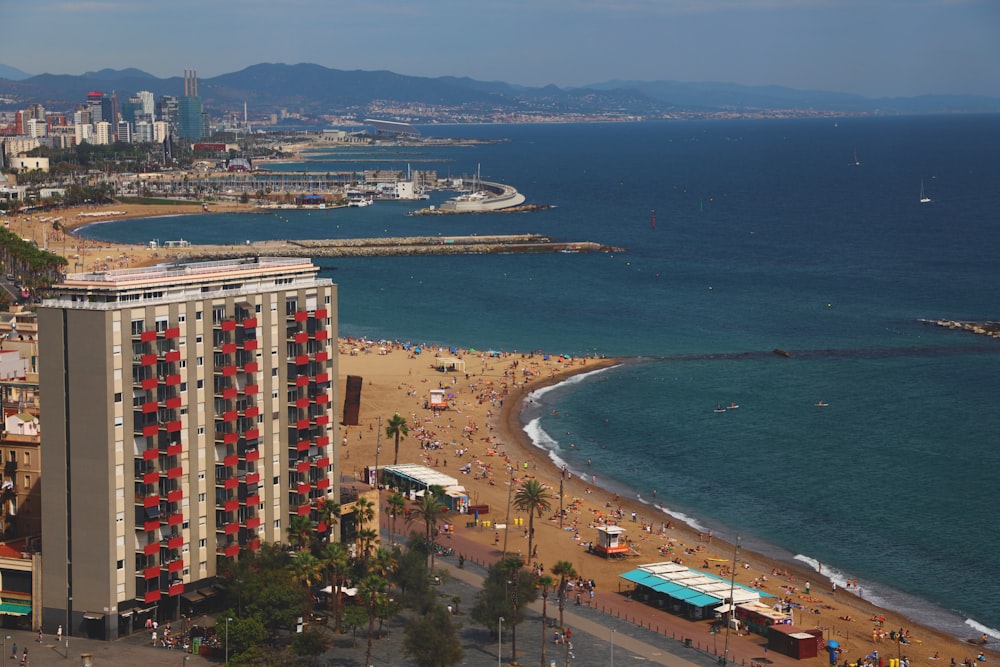 an aerial view of a beach with a hotel in the foreground