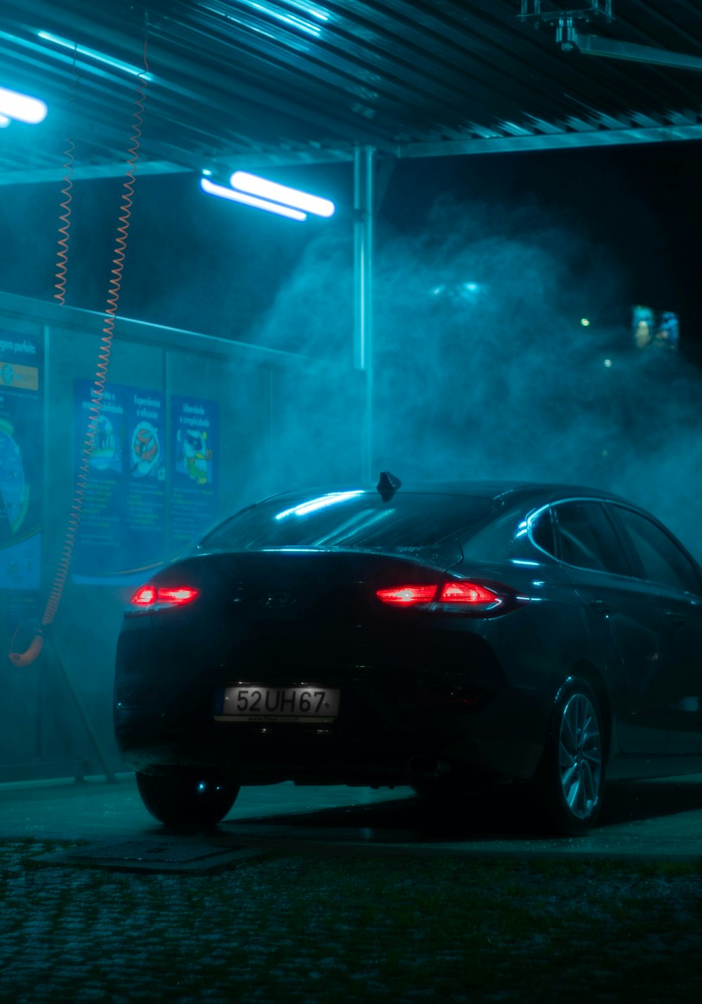 a car parked in a garage with smoke coming out of it