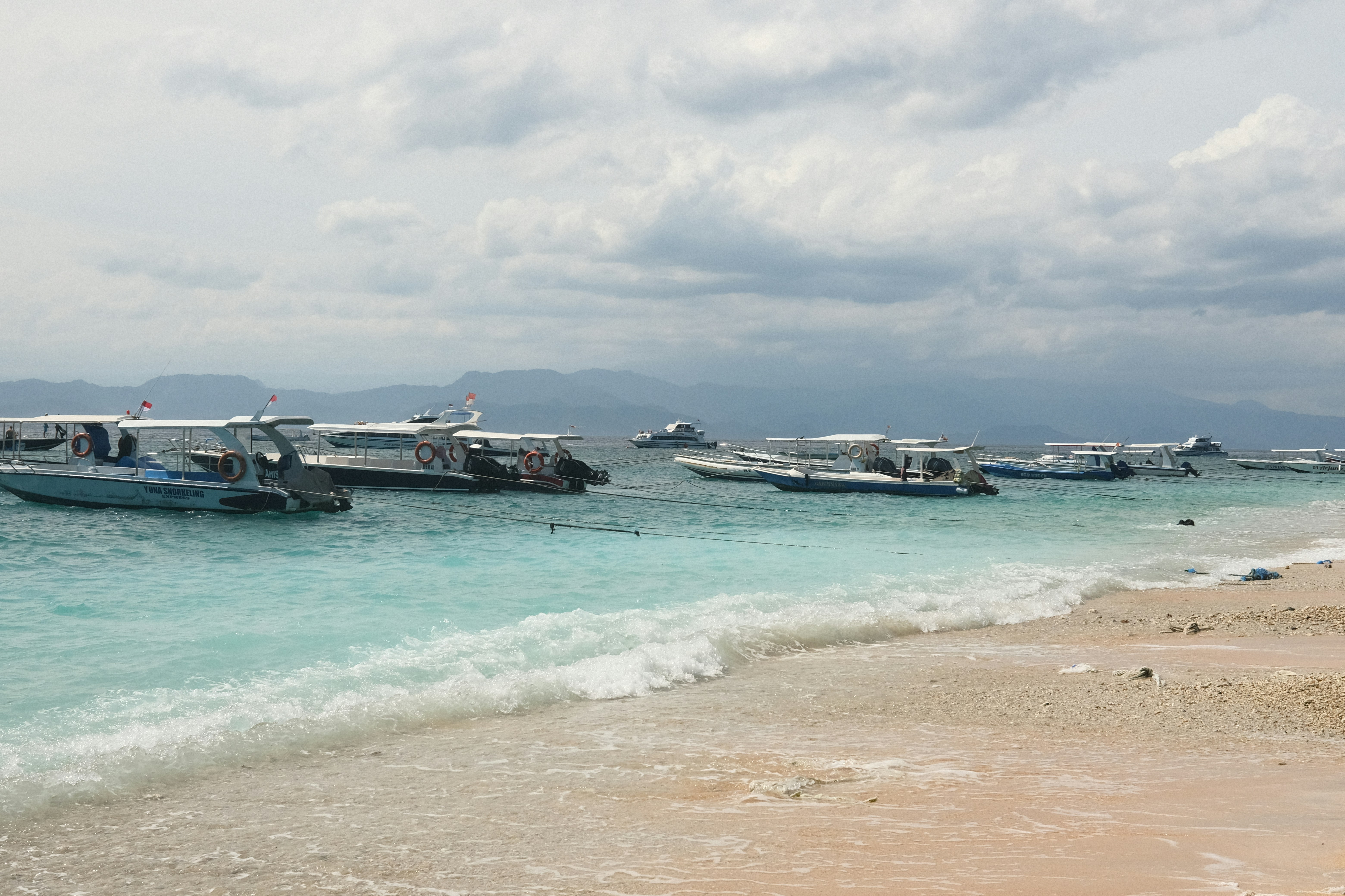 a group of boats that are sitting in the water
