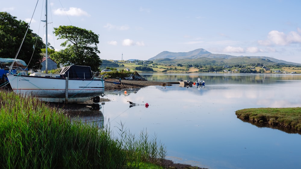 a boat sitting on the shore of a lake