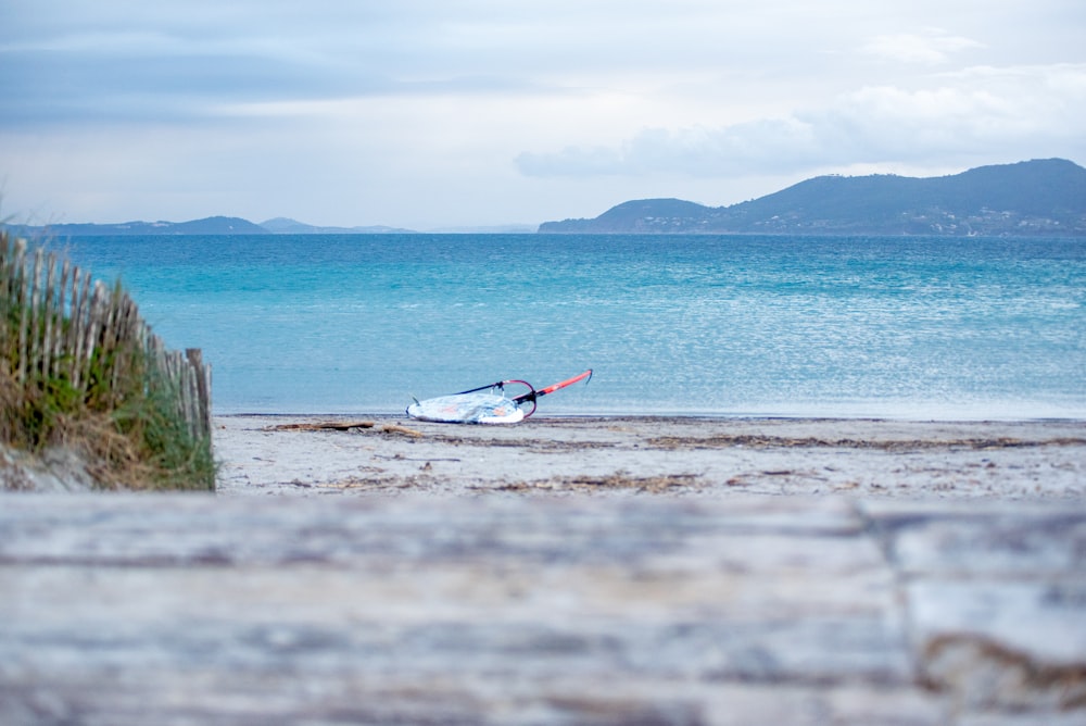 a small boat is sitting on the beach