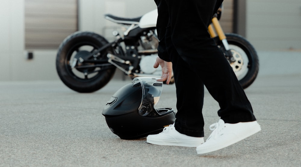 a person standing next to a parked motorcycle