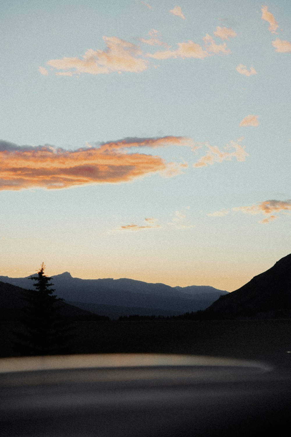 a view of a mountain range with a sunset in the background