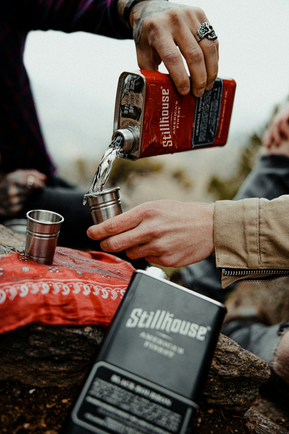 a person is pouring something into a cup