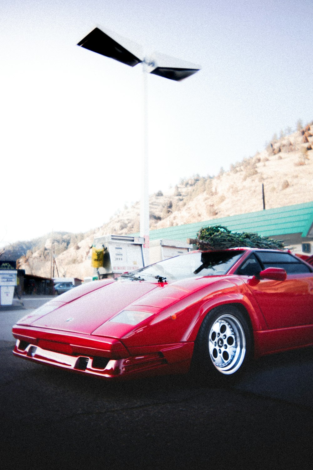 a red sports car parked in a parking lot