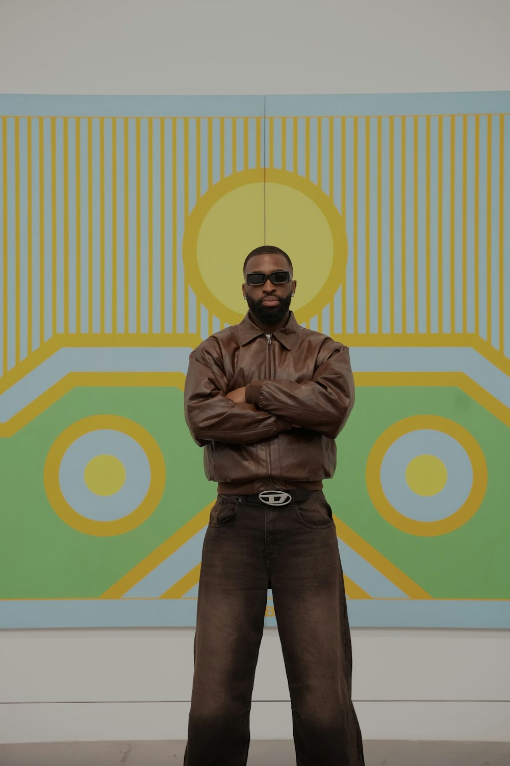 a man standing in front of a large painting