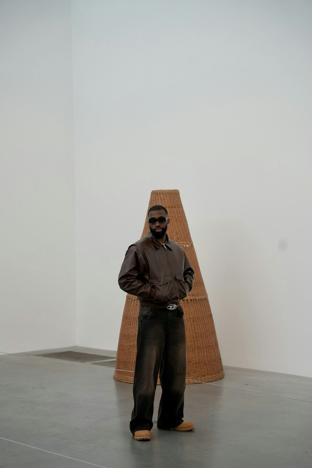 a man standing in front of a sculpture