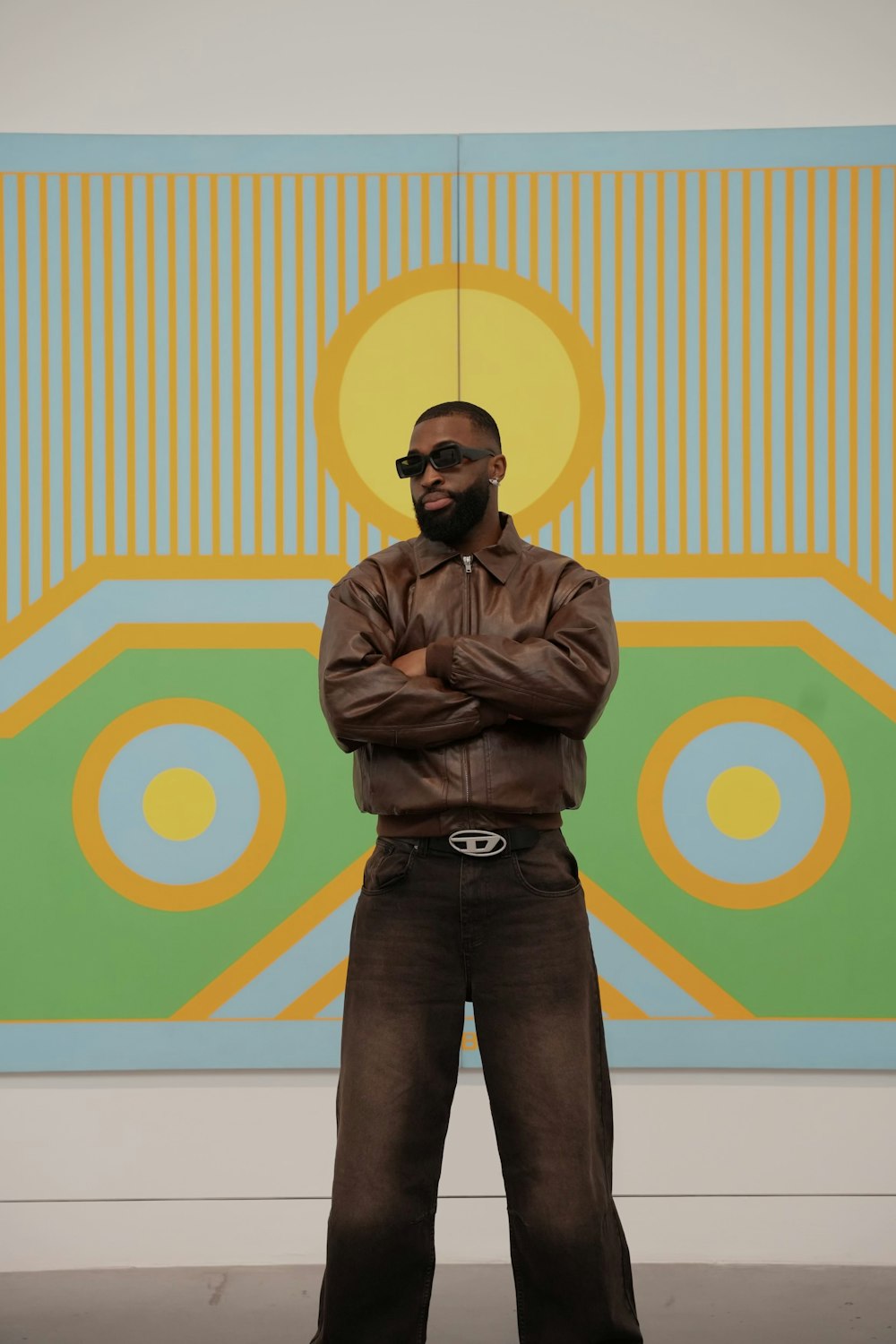 a man standing in front of a large painting