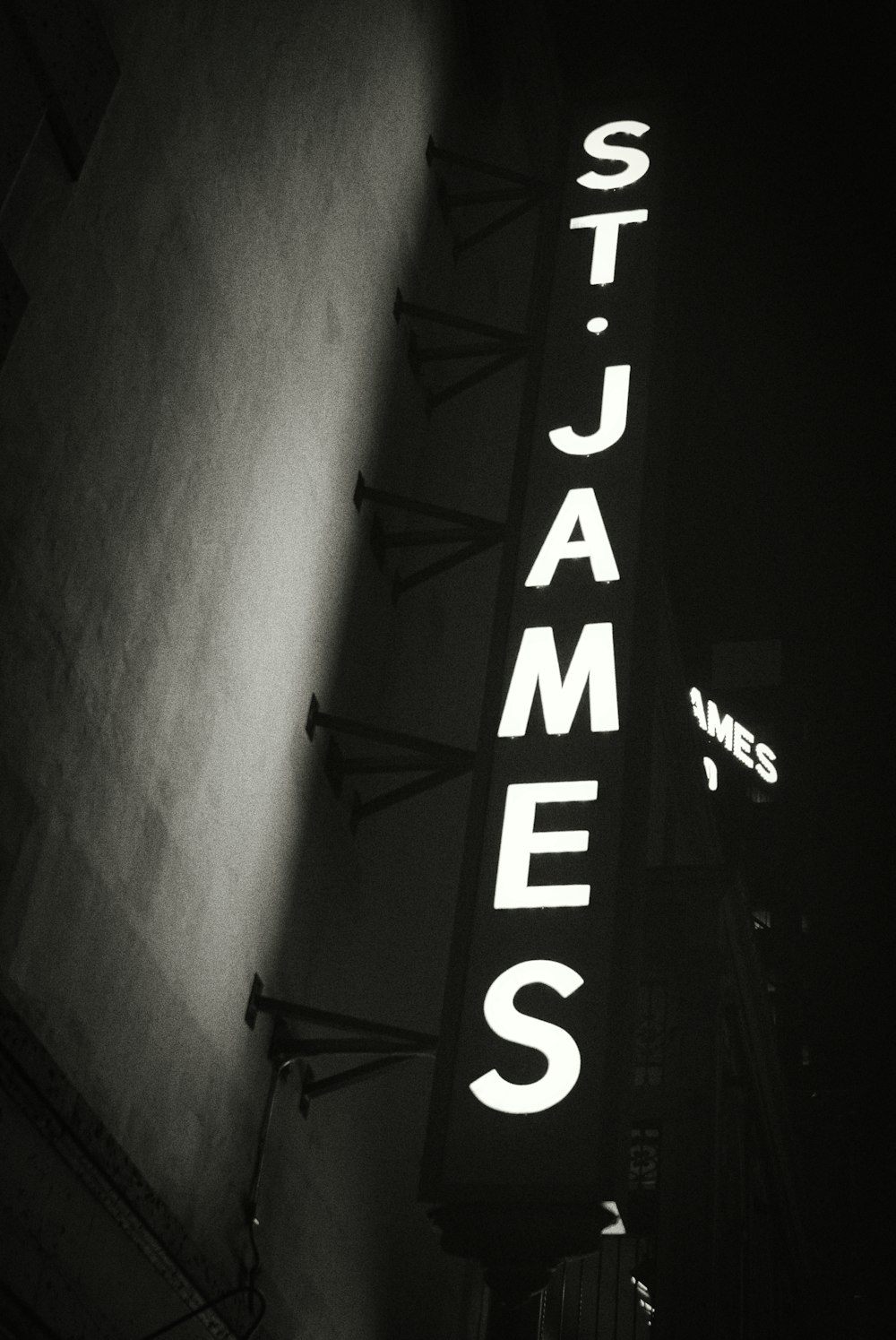 a black and white photo of a neon sign