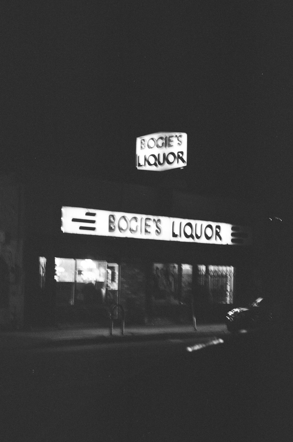a black and white photo of a liquor store