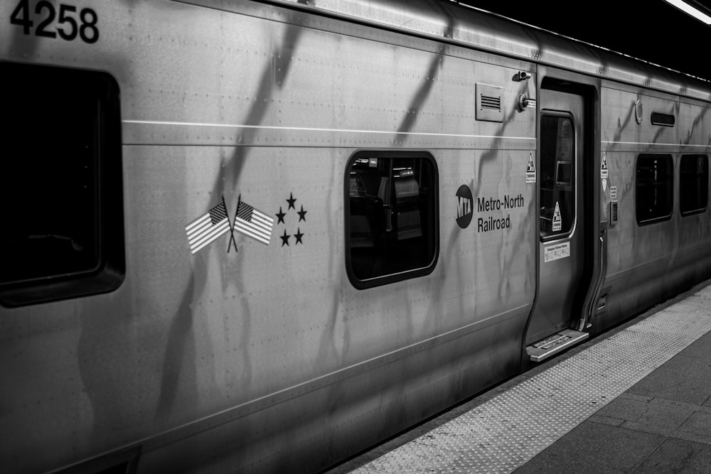 a black and white photo of a train at a station