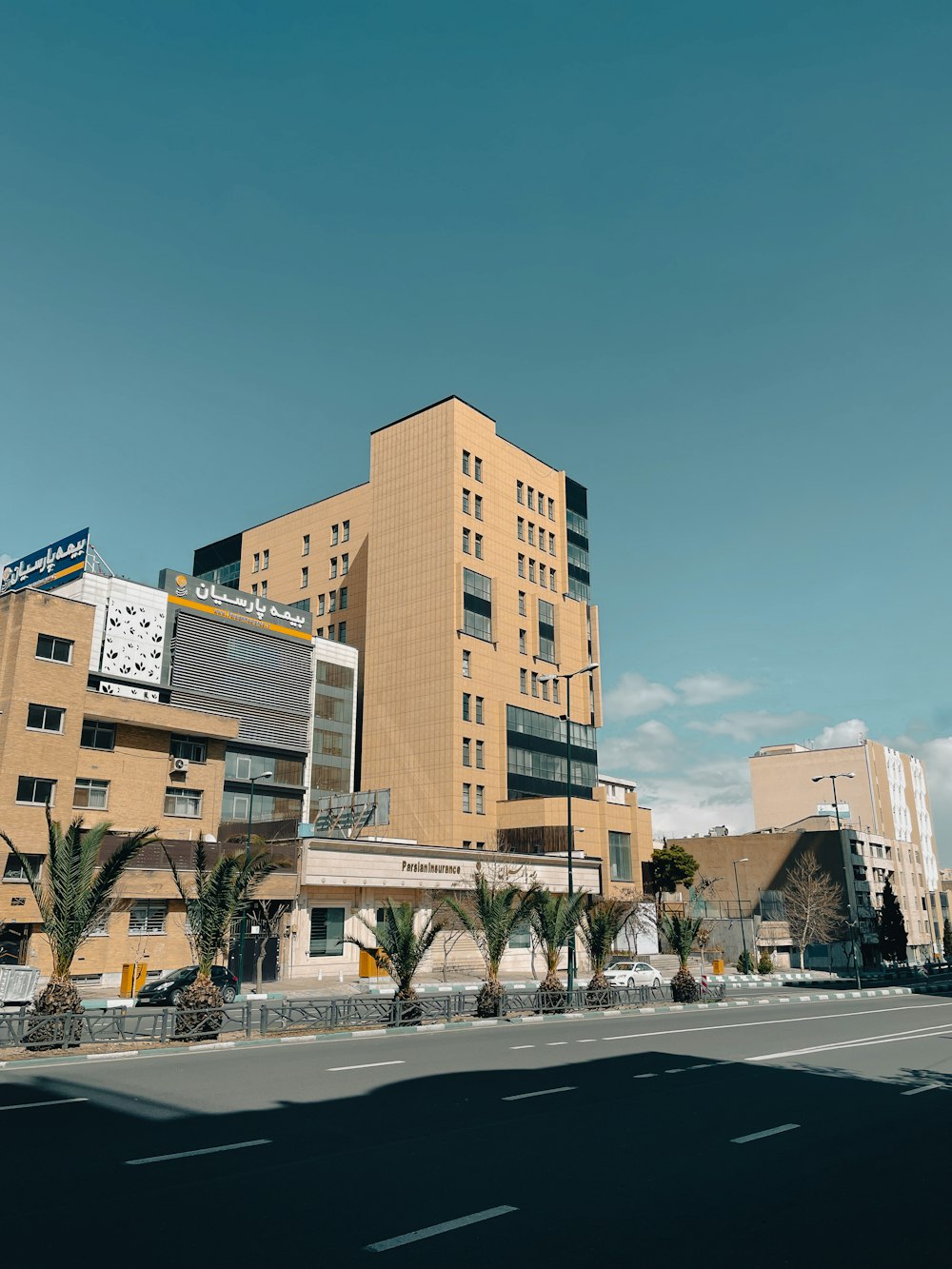 a large building with a lot of windows next to a street