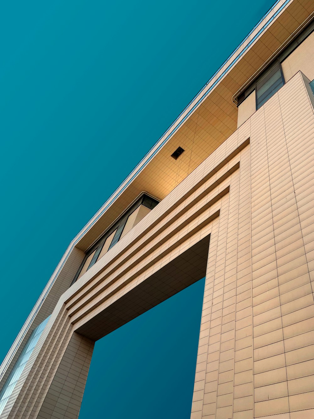 a tall white building with a sky background