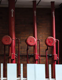 a row of red fire hydrants sitting next to each other