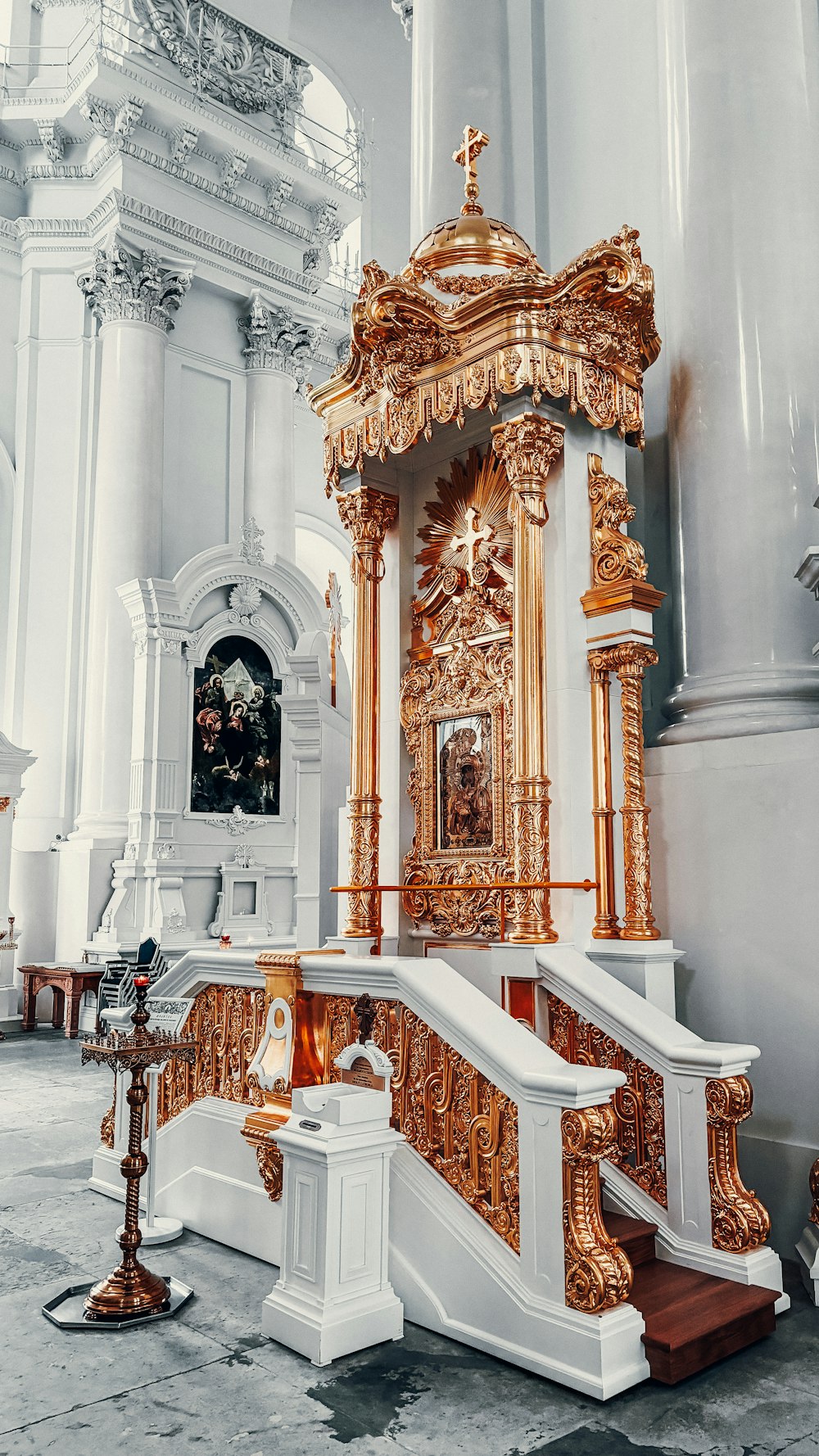 a golden alter in a church with white walls