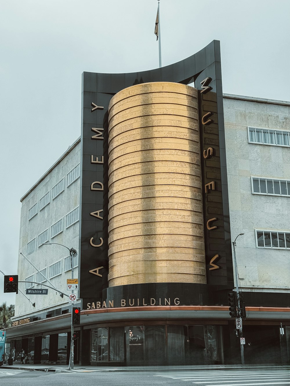 a tall building with a giant golden building on top of it