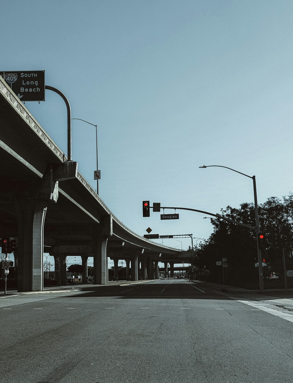 an empty street with a red traffic light