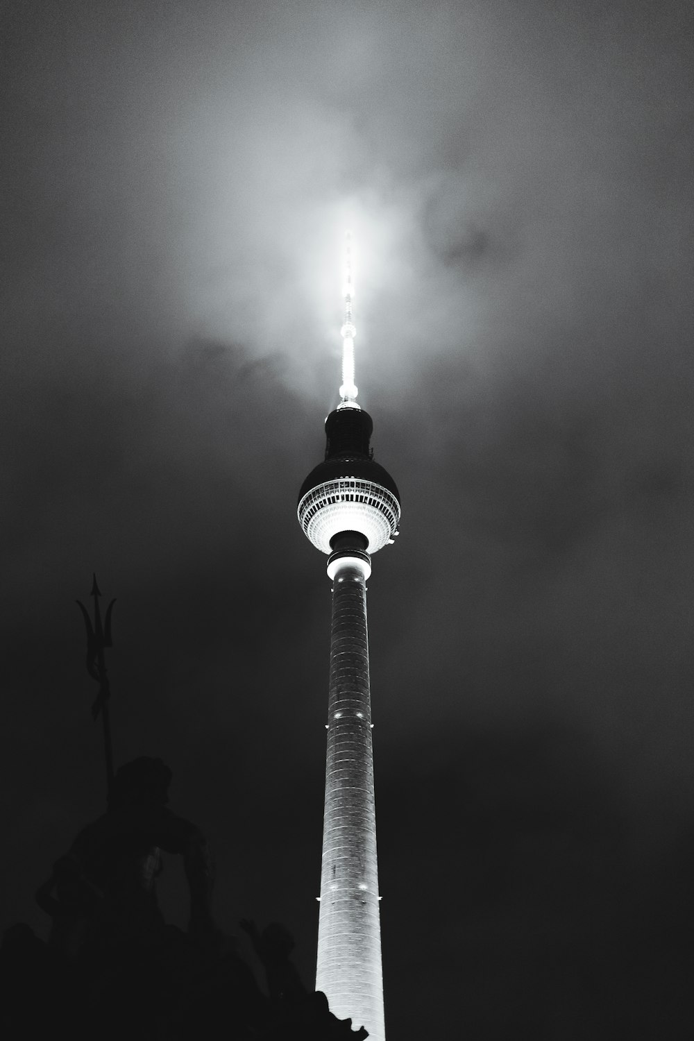 a black and white photo of a light tower