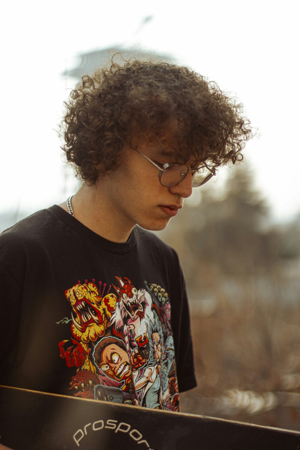 a young man holding a skateboard in his hands