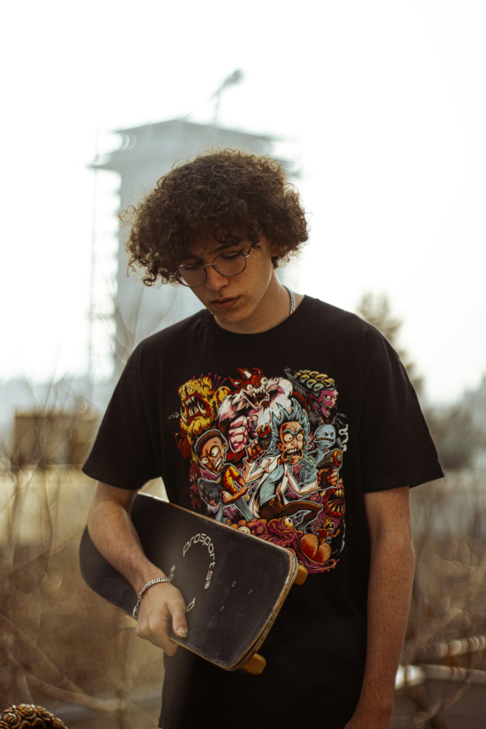 a young man holding a skateboard in his hands