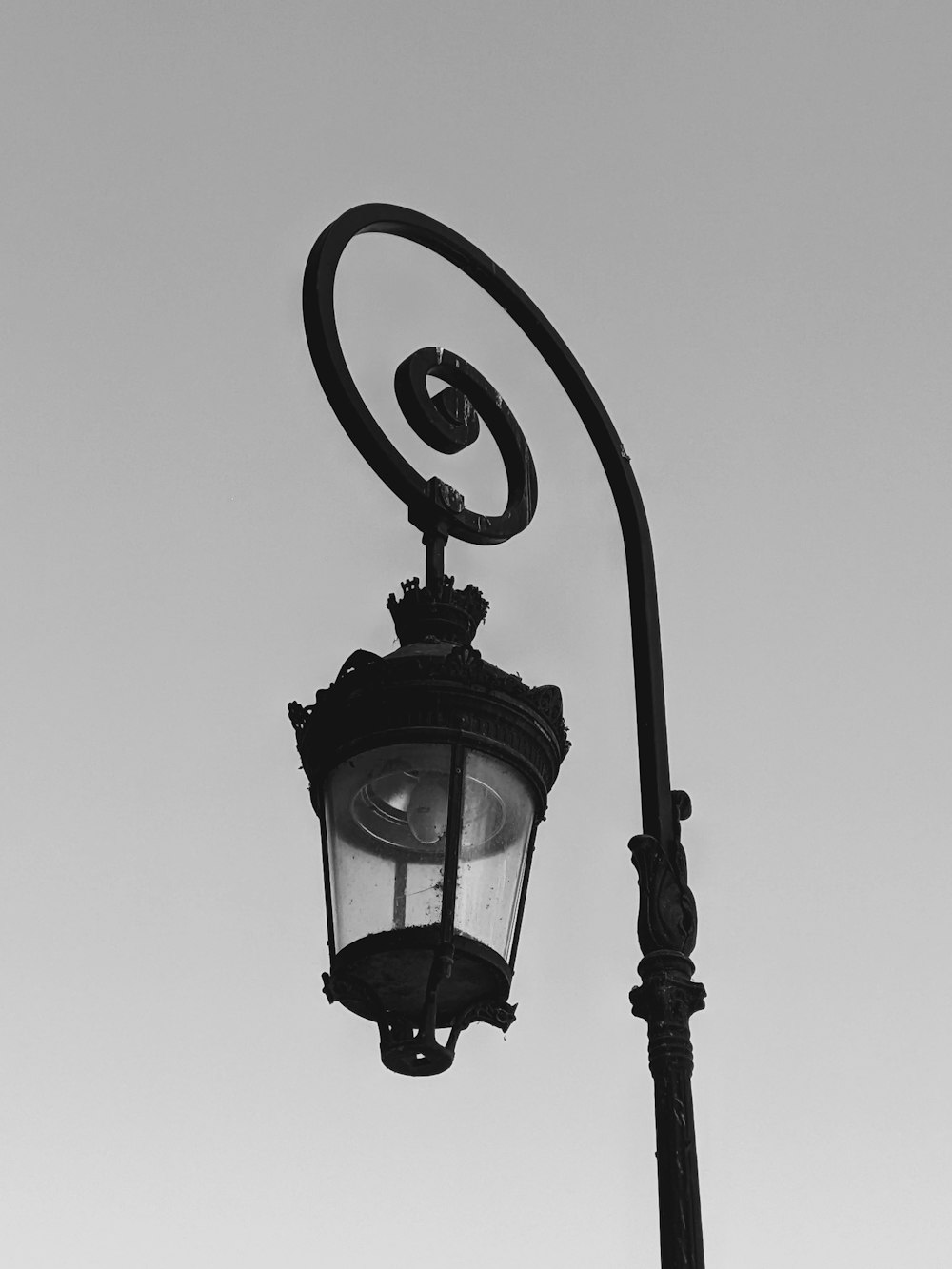 a black and white photo of a street light