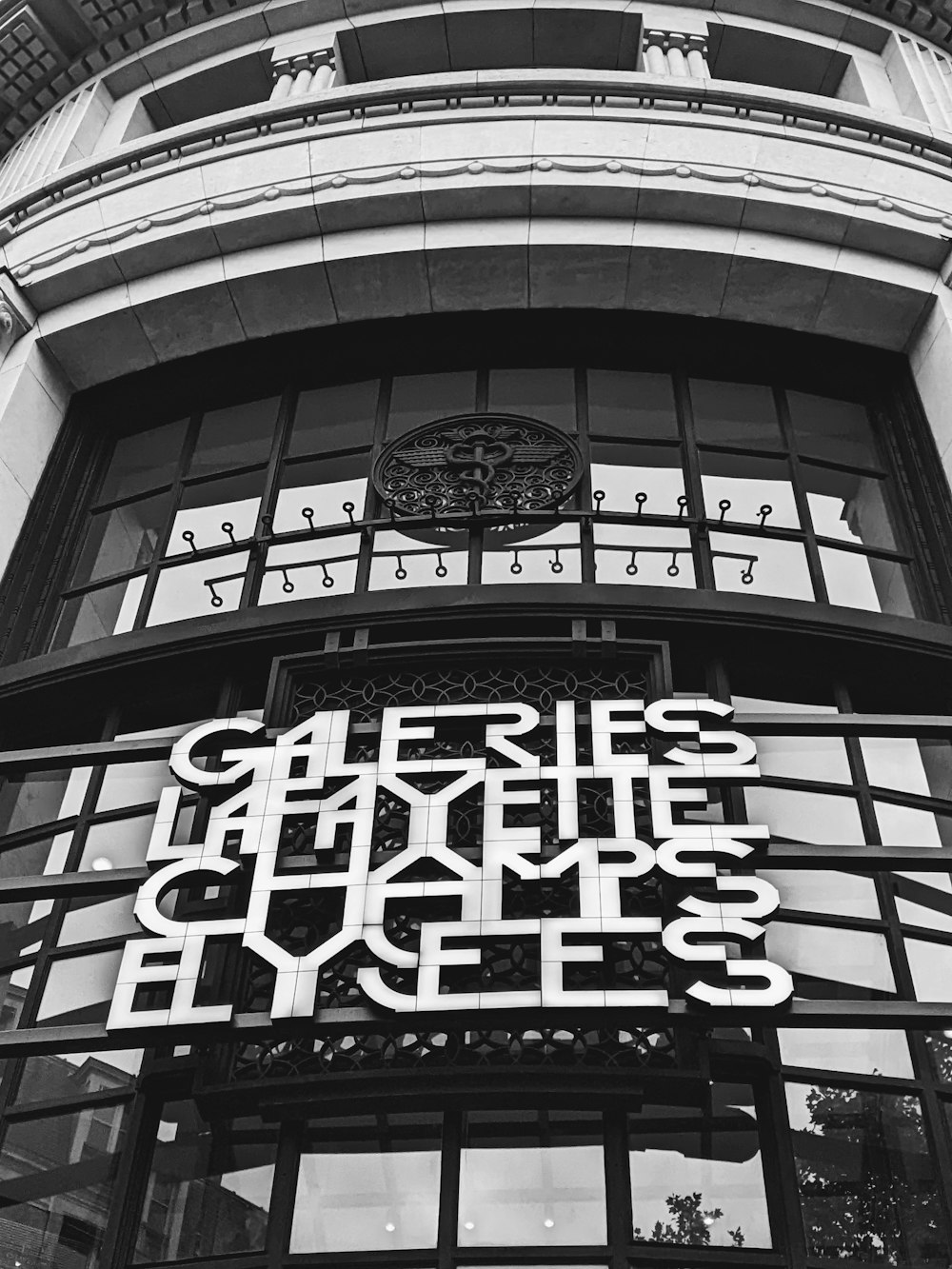 a black and white photo of a building with a clock