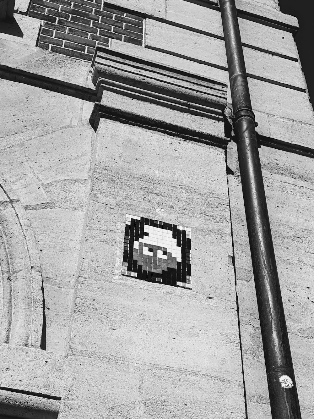 a black and white photo of a face on a building