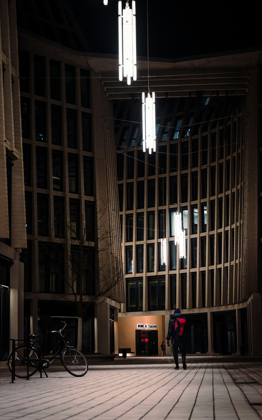 a person standing in front of a building at night