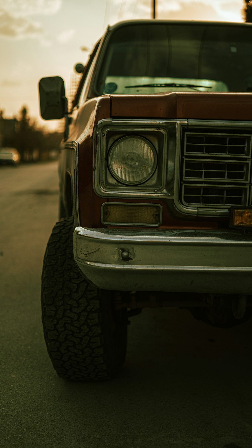 a red truck parked on the side of a road