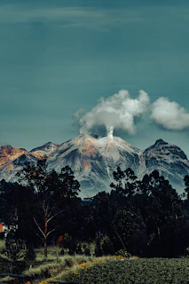 a view of a mountain range with clouds in the sky