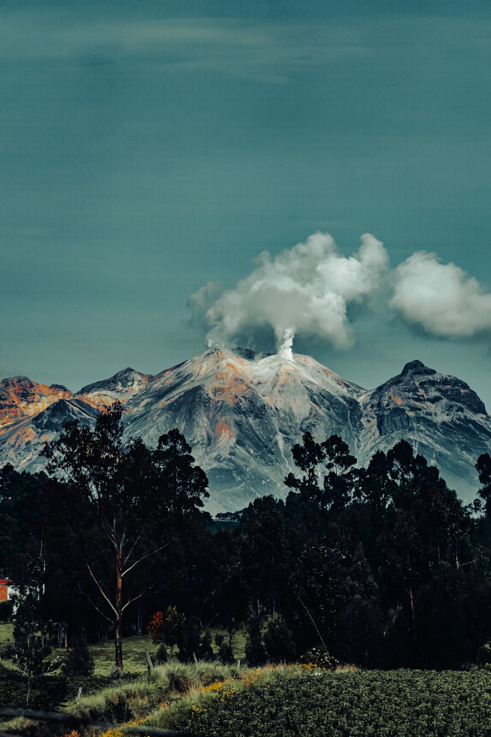 a view of a mountain range with clouds in the sky