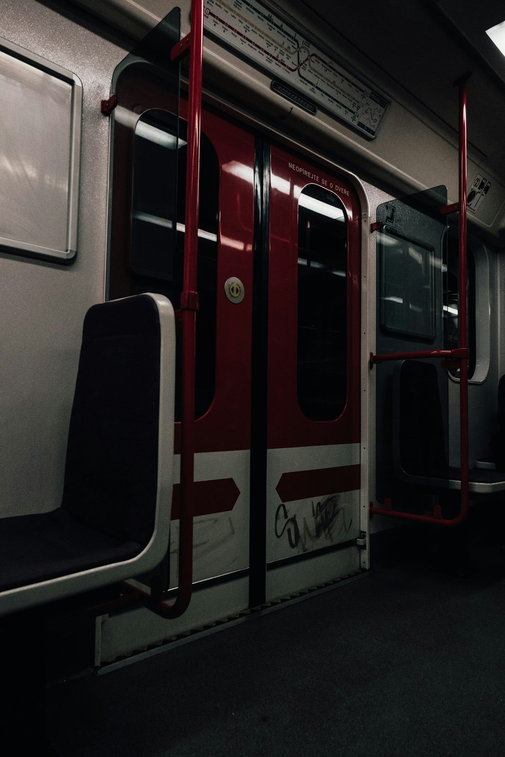 a red and white subway car with its doors open