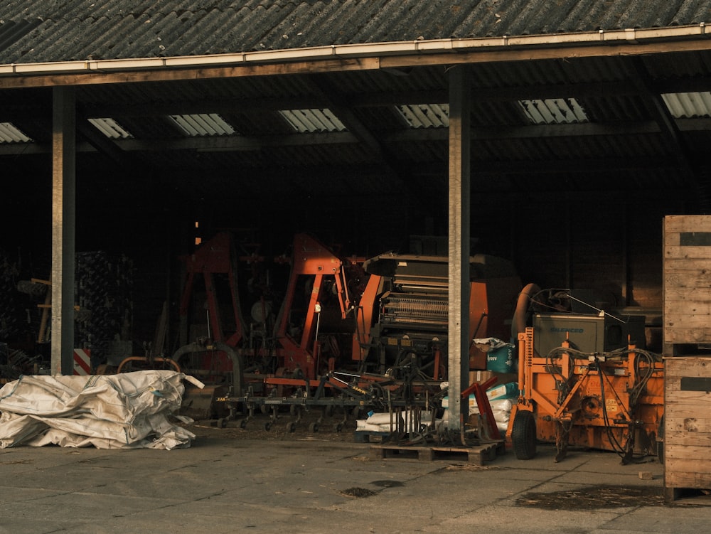 a garage filled with lots of junk next to a building