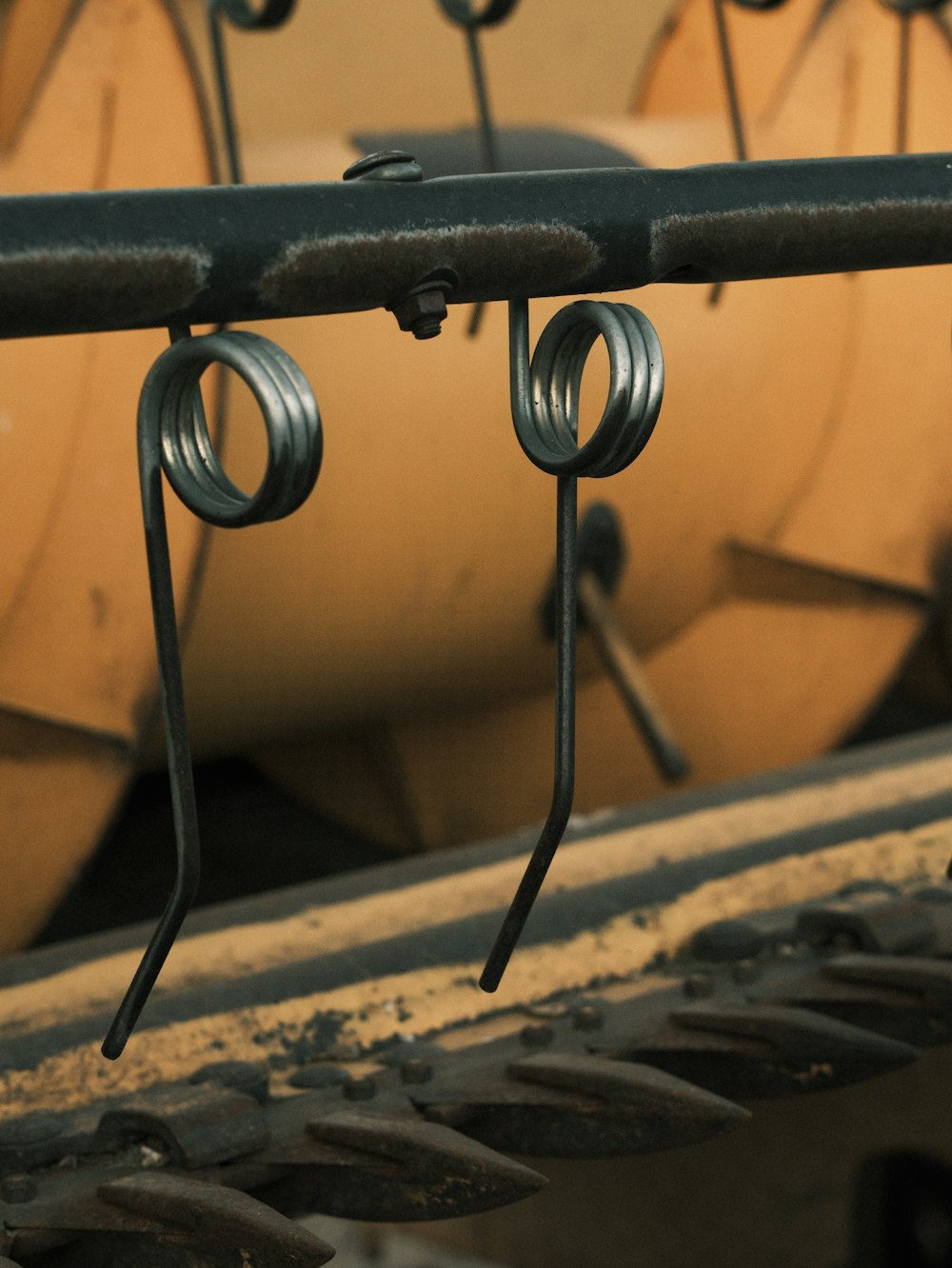 a close up of a metal bar with a bunch of wires hanging from it