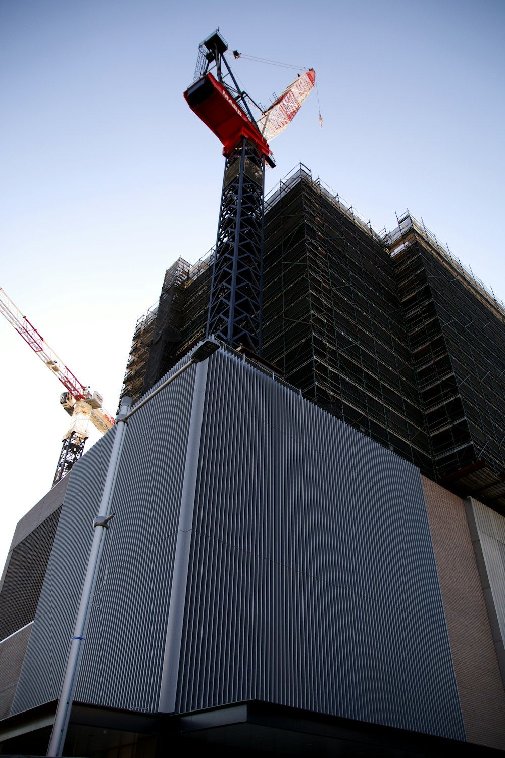 a tall building with a crane on top of it