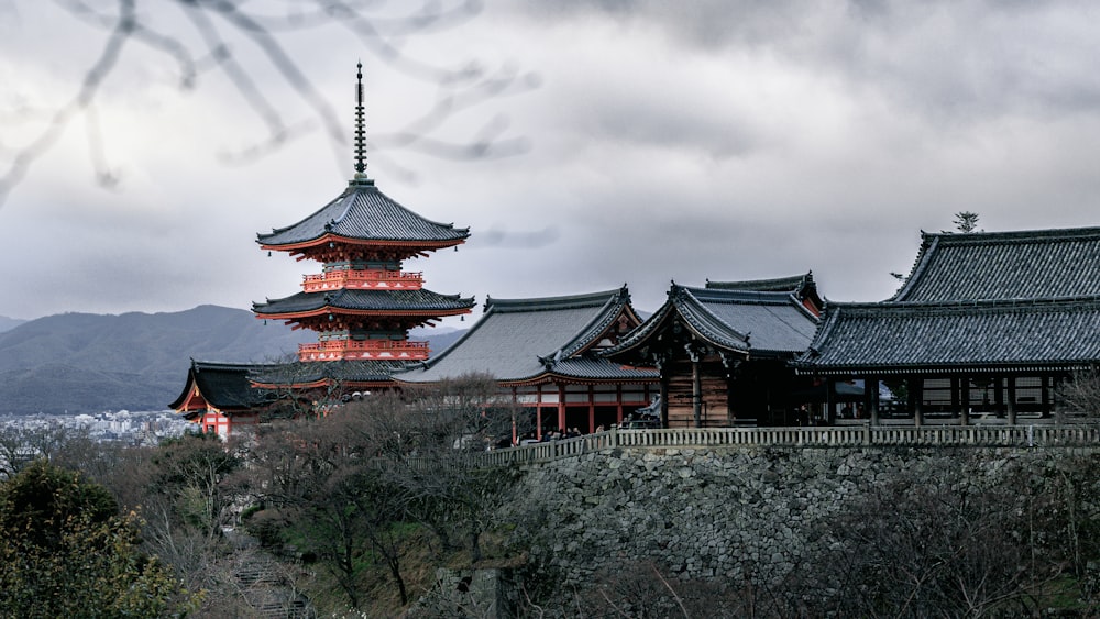 a tall building sitting on top of a lush green hillside