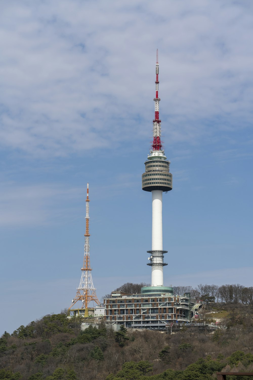 a very tall tower on top of a hill