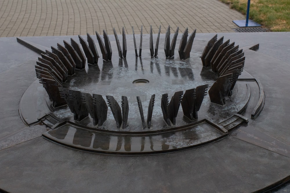 a circular sculpture with a bunch of knives sticking out of it