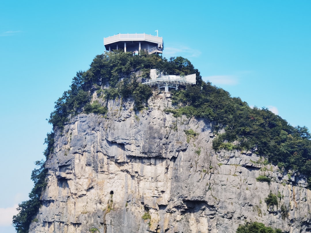 a house on top of a mountain on a clear day,