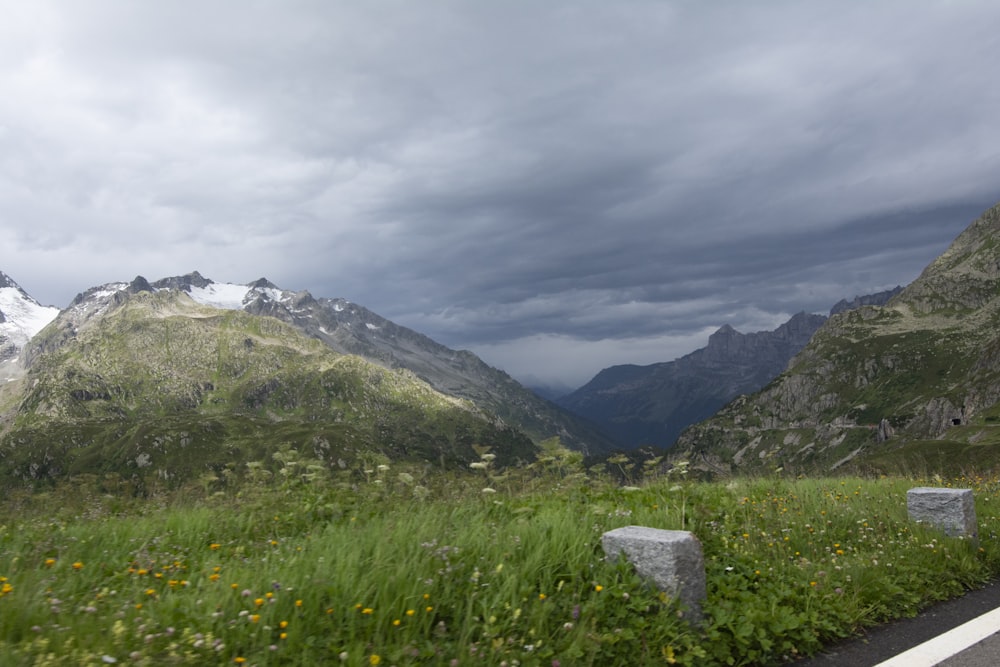 a scenic view of a mountain range with a cloudy sky