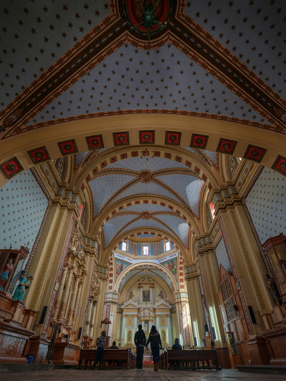 a couple of people that are standing in a church