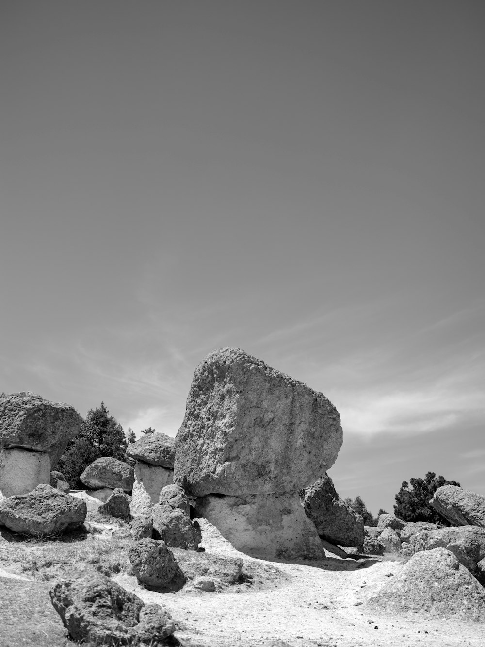 a black and white photo of rocks in the desert