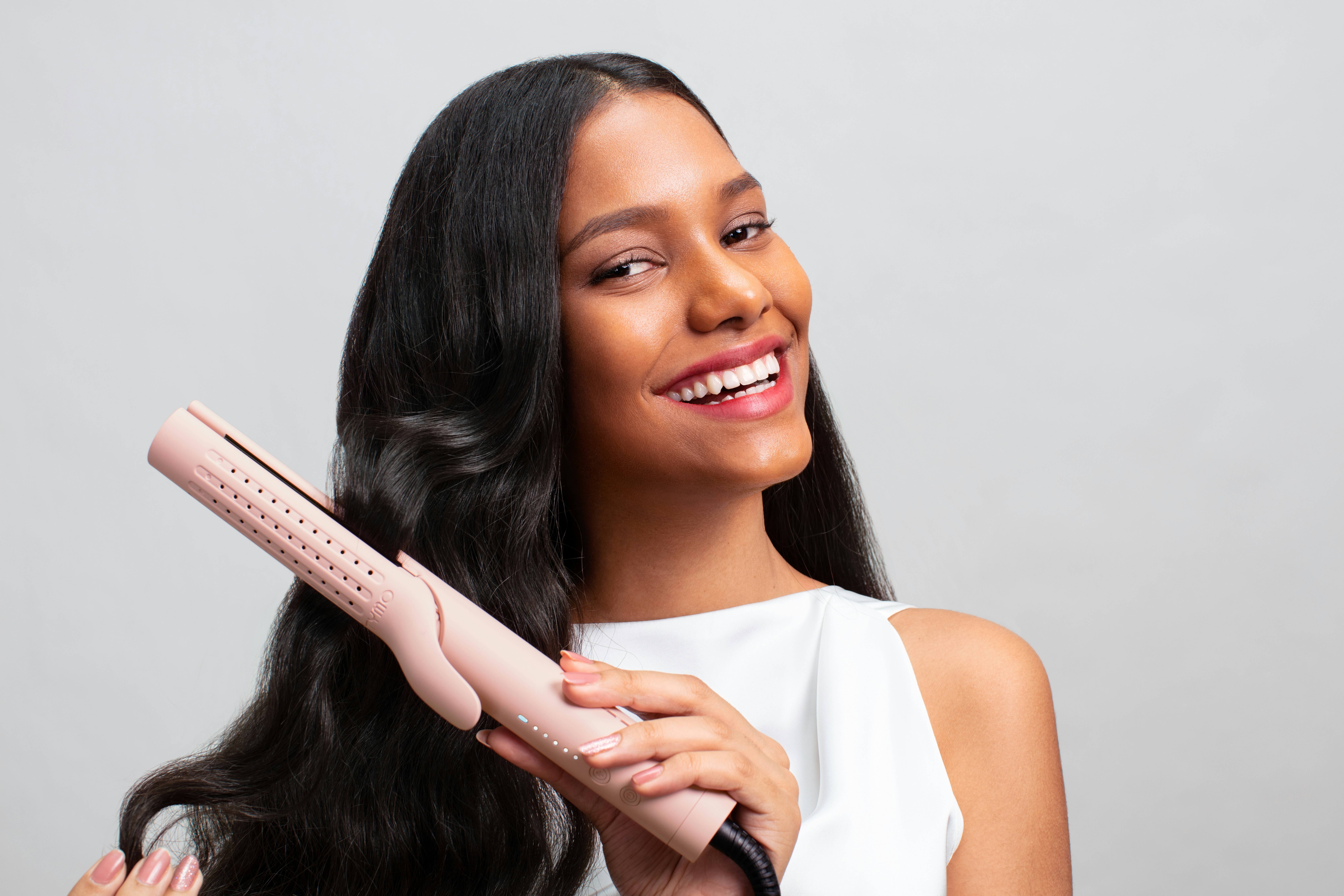 a woman holding a hair dryer in her hand