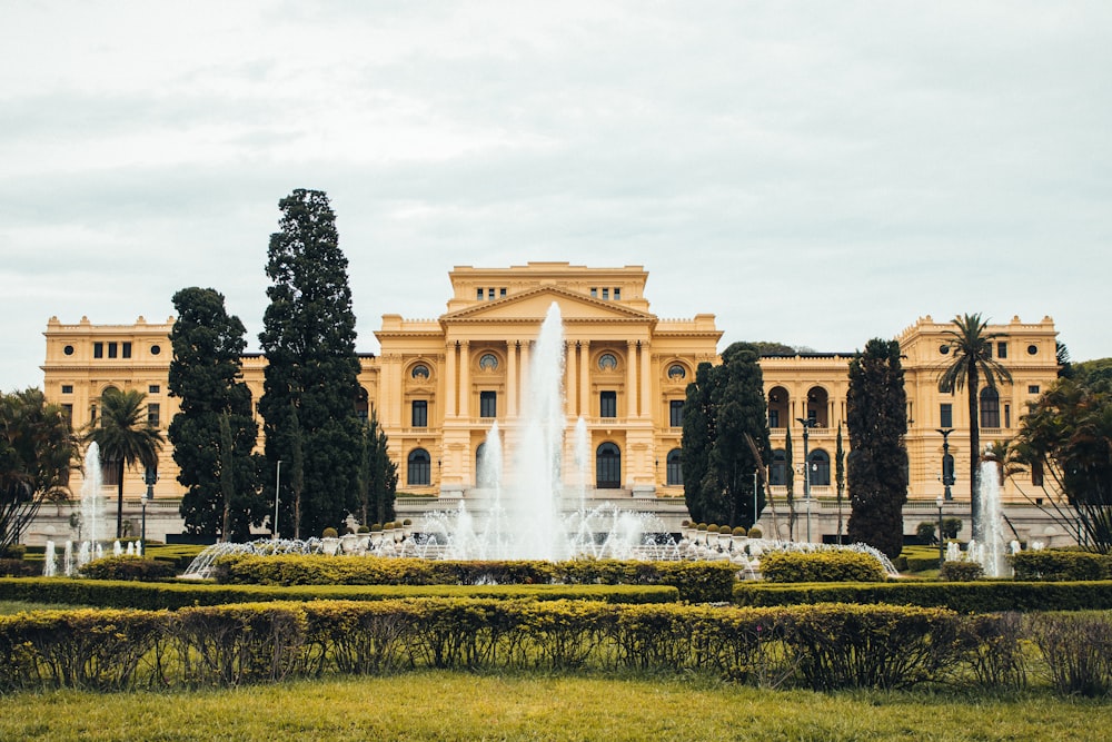 a large building with a fountain in front of it