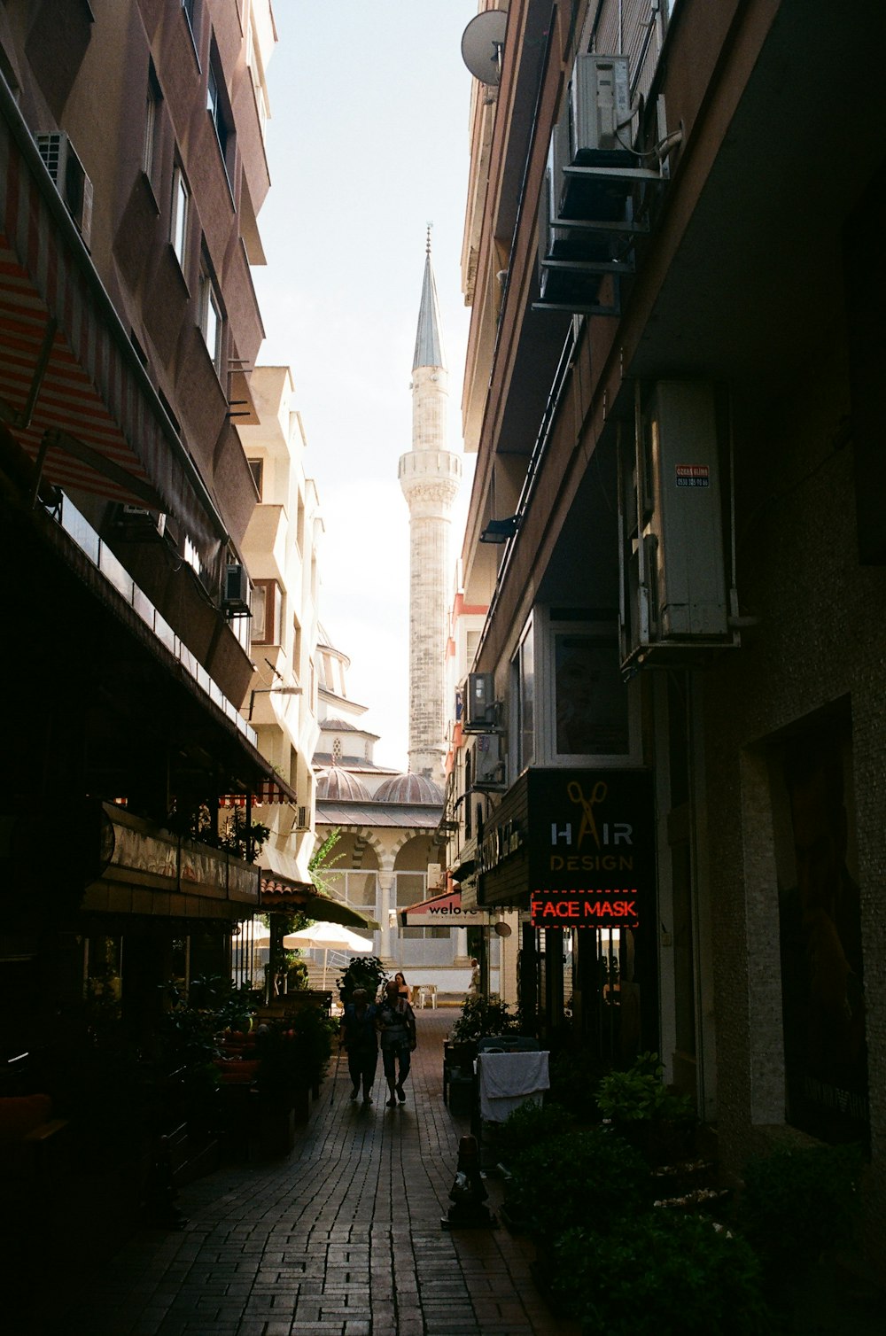 a couple of people that are walking down a street